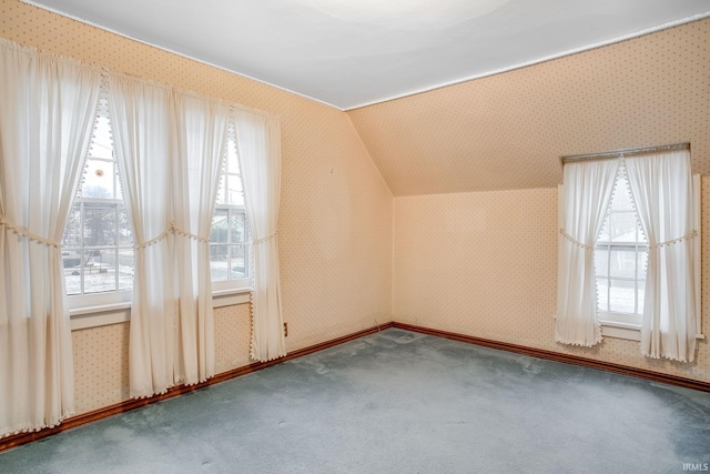 additional living space with plenty of natural light, carpet, and vaulted ceiling