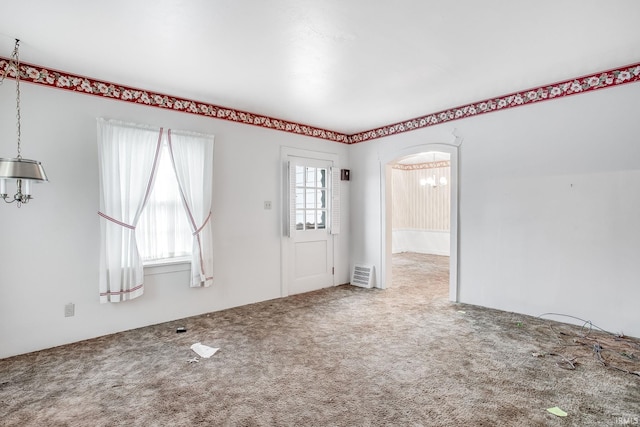 interior space with carpet flooring and a chandelier