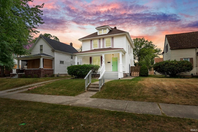 view of front of home with a lawn and covered porch