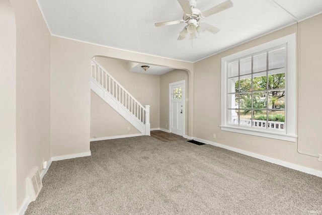 carpeted entryway featuring ceiling fan