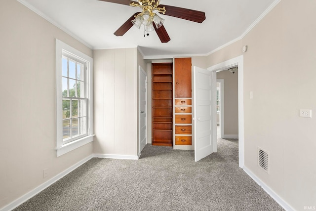 unfurnished bedroom featuring carpet, ceiling fan, ornamental molding, and a closet