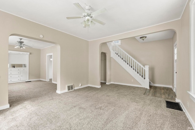 unfurnished living room featuring carpet flooring and ceiling fan