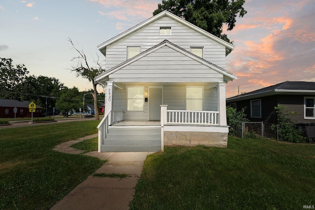 view of front of home with a yard and a porch