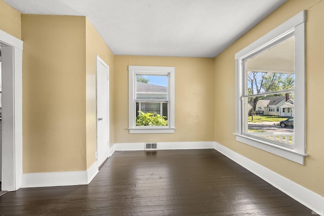 spare room featuring dark hardwood / wood-style floors