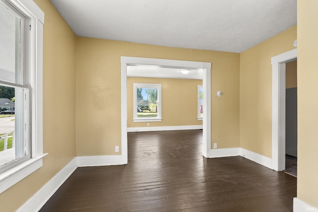 spare room with dark hardwood / wood-style floors