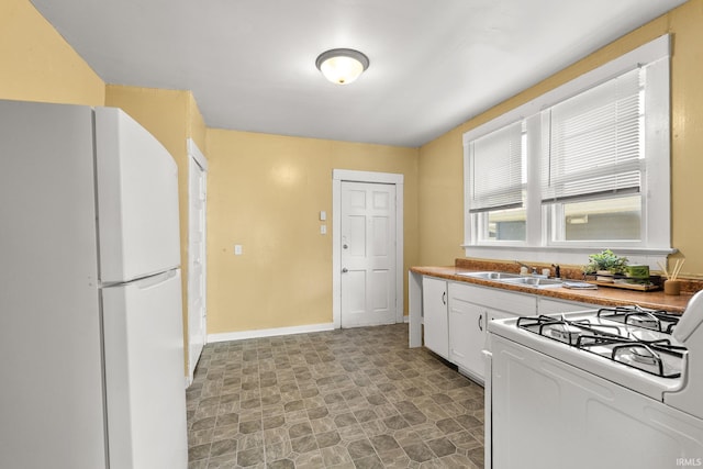 kitchen featuring white cabinets, white appliances, and sink