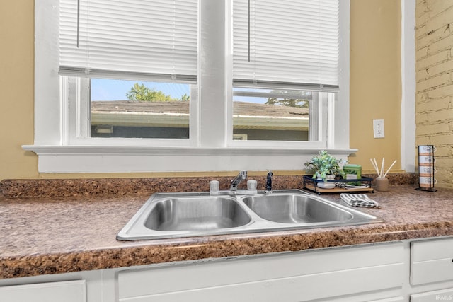 details featuring white cabinets and sink