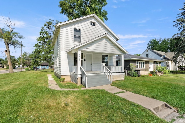 view of front of home with a porch and a front yard