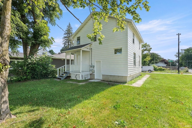 back of property featuring a lawn