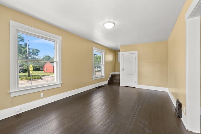 spare room with dark hardwood / wood-style flooring