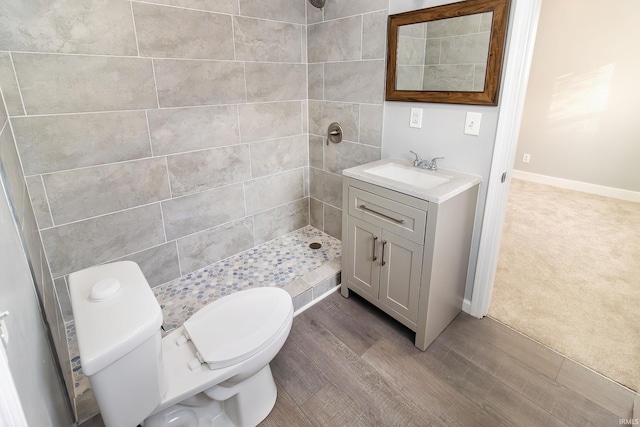 bathroom featuring vanity, hardwood / wood-style flooring, toilet, and walk in shower