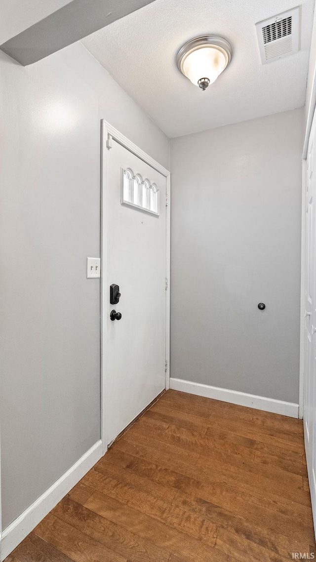 doorway with hardwood / wood-style floors