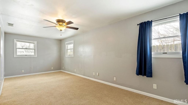 carpeted empty room featuring ceiling fan