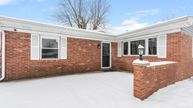 view of snow covered property entrance