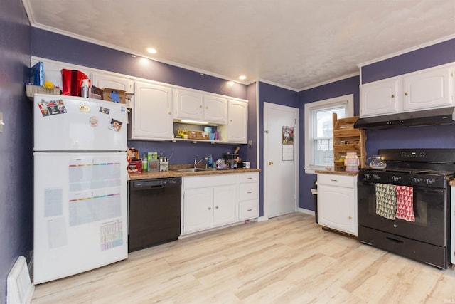 kitchen with white cabinetry, sink, dark stone counters, black appliances, and light wood-type flooring