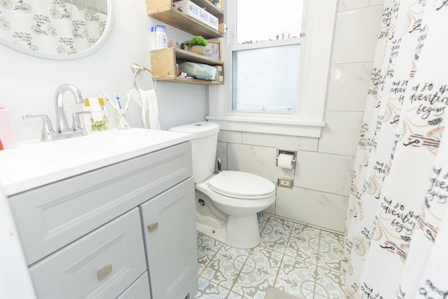 bathroom with vanity, tile walls, tile patterned flooring, toilet, and curtained shower