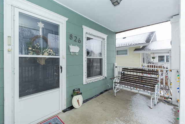 view of exterior entry featuring a porch