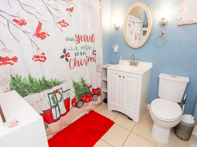 bathroom featuring tile patterned flooring, vanity, and toilet