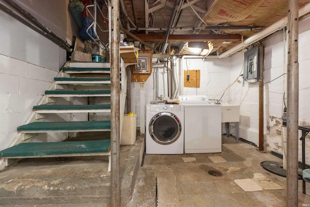 laundry room with washing machine and clothes dryer and electric panel