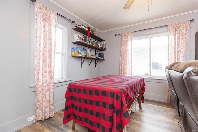 bedroom featuring light hardwood / wood-style flooring, ceiling fan, and ornamental molding