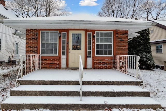 view of snow covered property entrance