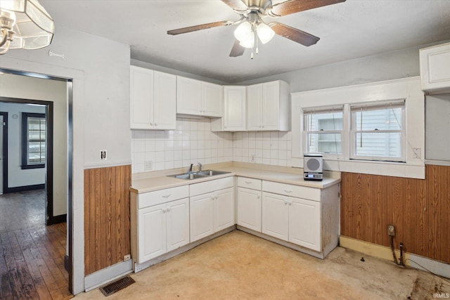 kitchen featuring ceiling fan, white cabinetry, sink, and tasteful backsplash