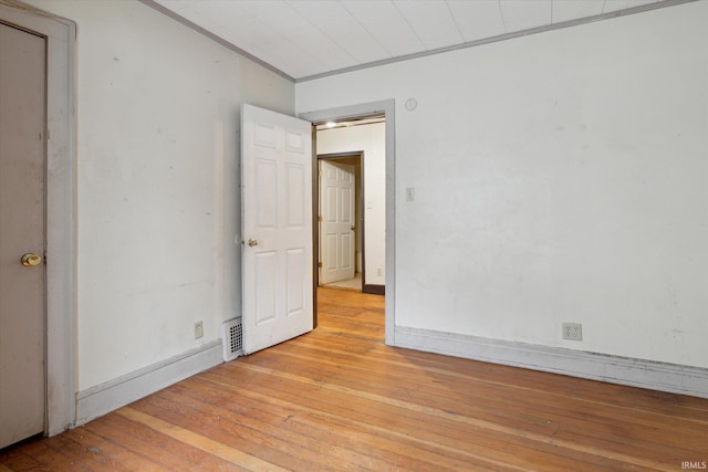 unfurnished room with light hardwood / wood-style floors and ornamental molding