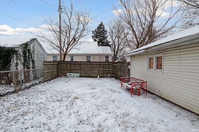 view of yard layered in snow