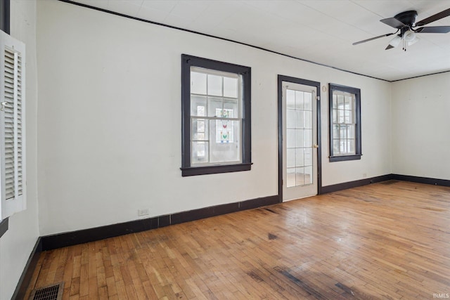 unfurnished room with light hardwood / wood-style floors, a wealth of natural light, and ceiling fan