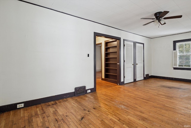 unfurnished bedroom with ceiling fan and light hardwood / wood-style flooring