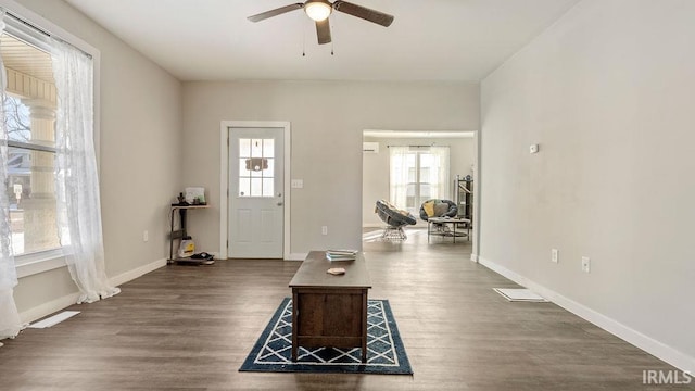 foyer entrance with ceiling fan and dark hardwood / wood-style flooring