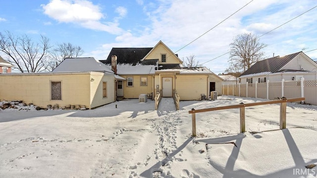 view of snow covered rear of property