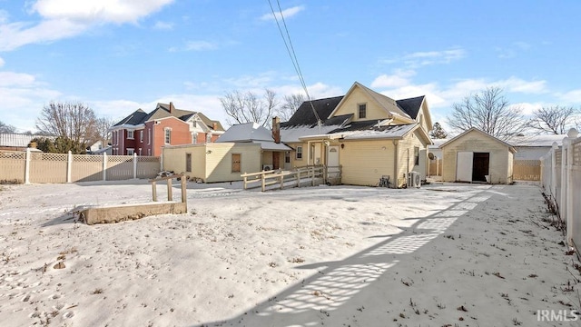 snow covered property with a storage unit