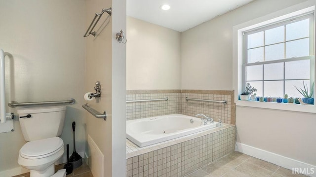 bathroom featuring tile patterned floors, a relaxing tiled tub, and toilet