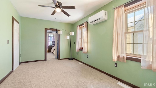 carpeted empty room featuring ceiling fan and a wall unit AC