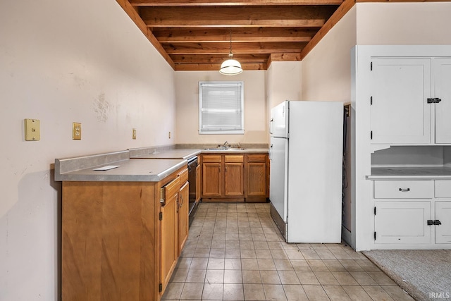 kitchen featuring pendant lighting, sink, beam ceiling, white fridge, and range