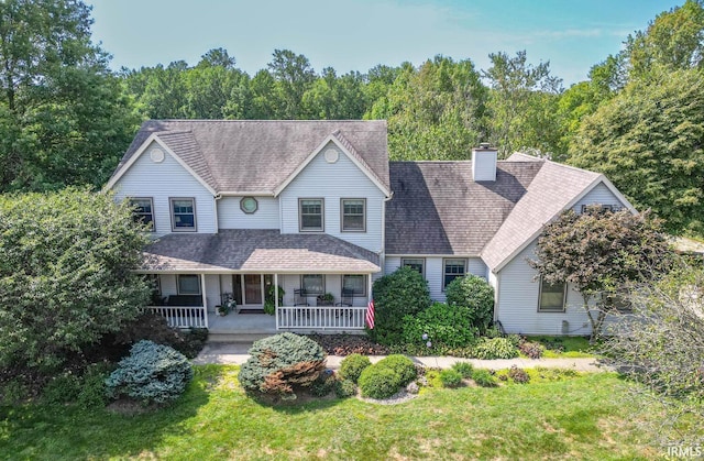 view of front of house with a front yard and covered porch