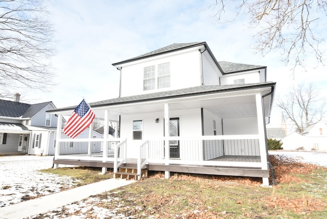 back of property with a porch