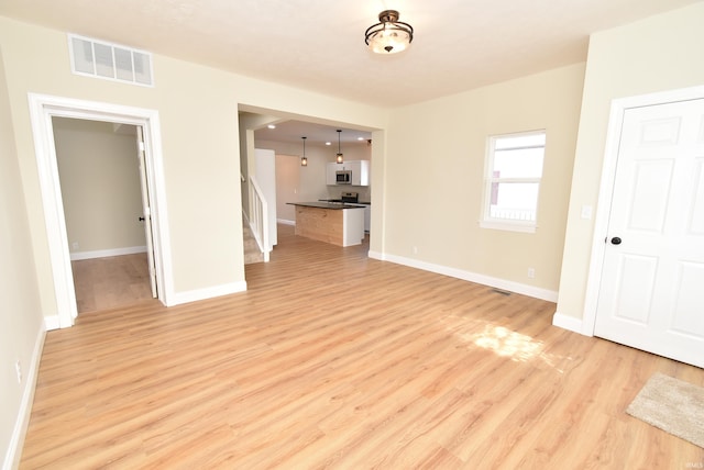 unfurnished living room with light wood-type flooring