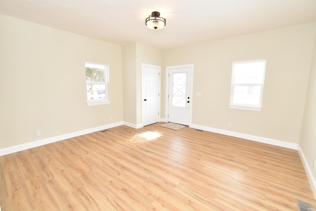 unfurnished room with light hardwood / wood-style flooring