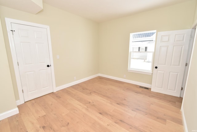 spare room with light wood-type flooring