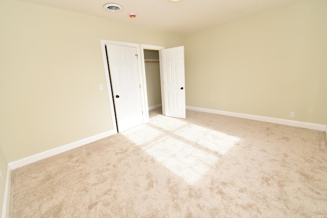 unfurnished bedroom featuring light colored carpet