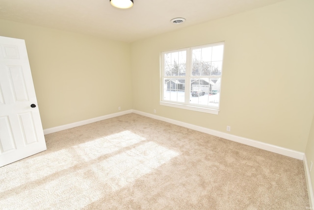 spare room with light carpet