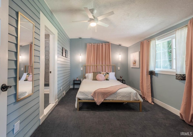 carpeted bedroom featuring vaulted ceiling, ceiling fan, and a textured ceiling