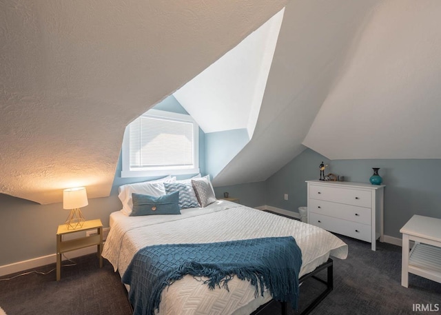 carpeted bedroom with a textured ceiling and vaulted ceiling