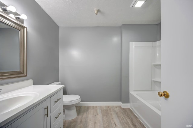 full bathroom with shower / bath combination, vanity, a textured ceiling, hardwood / wood-style floors, and toilet