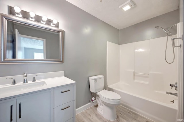 full bathroom featuring vanity, toilet, a textured ceiling, wood-type flooring, and tub / shower combination