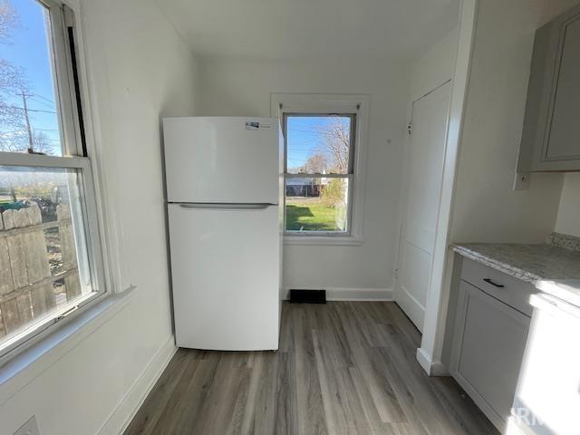 kitchen featuring white fridge and hardwood / wood-style flooring