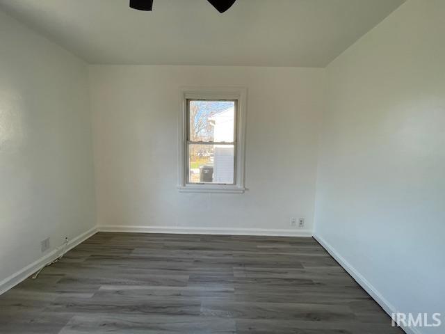 spare room featuring dark hardwood / wood-style floors and ceiling fan