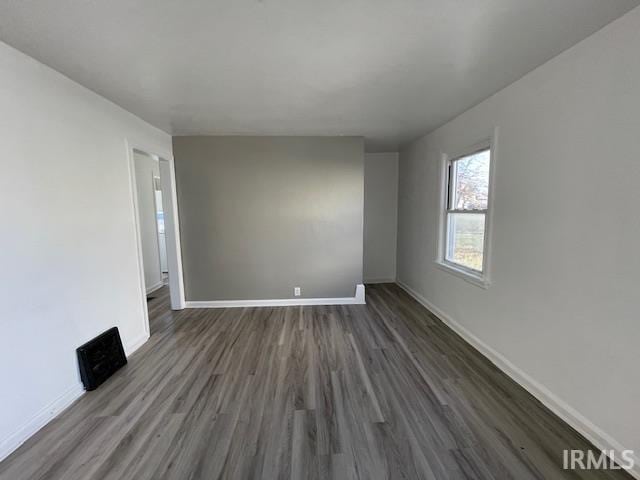 empty room with dark wood-type flooring